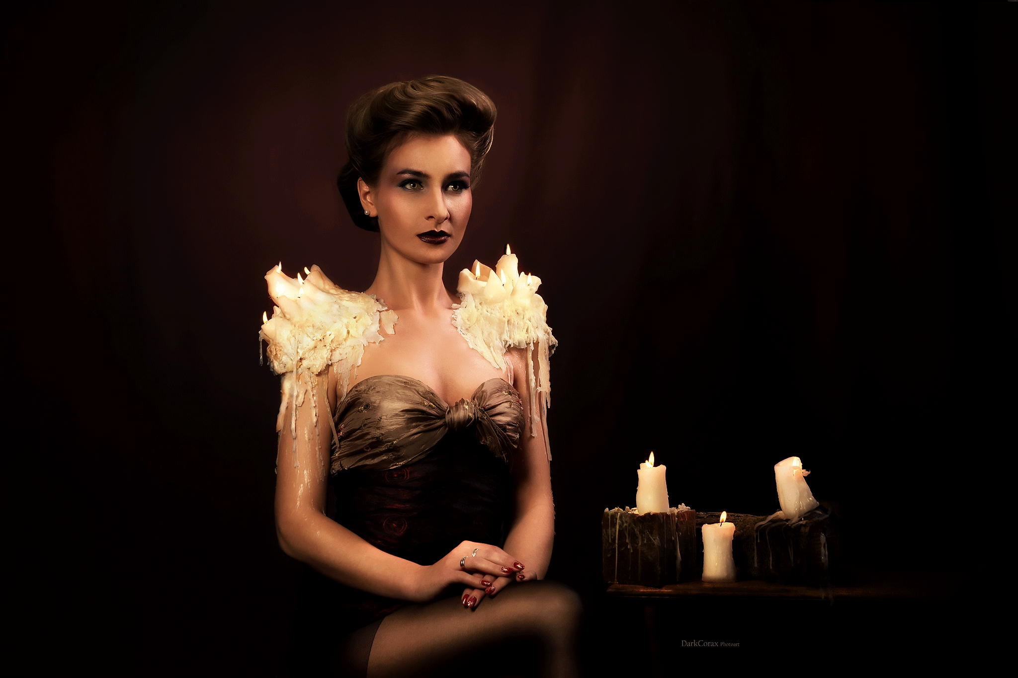 Modern reinterpretation of the Gibson Girl hairstyle, featuring model Anna Povarova with burning wax candles arranged as shoulder pads.