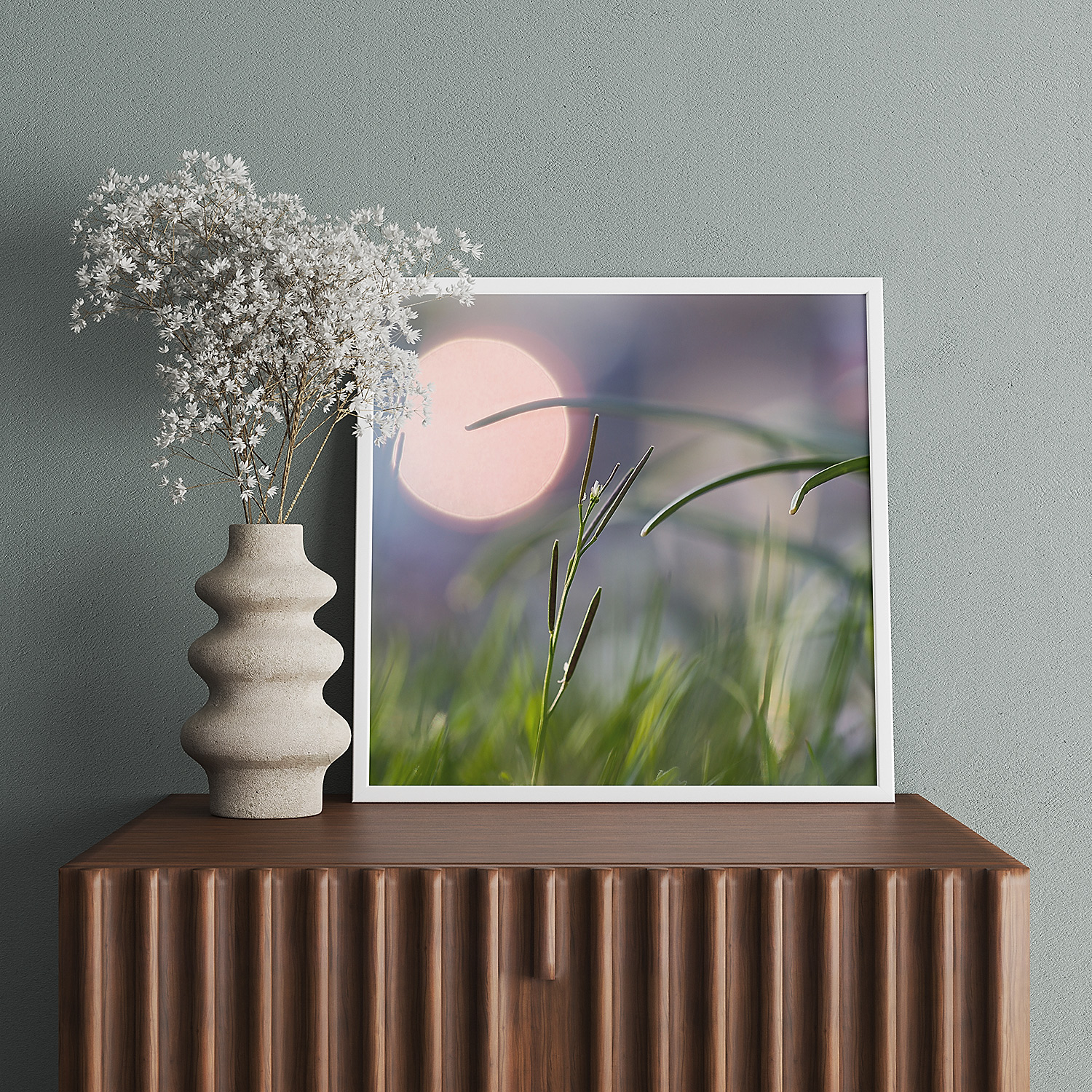 Wooden sideboard with framed 'Twilight Breeze' image and stone flower vase.