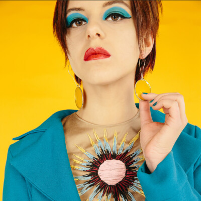 Step back in time to the swinging sixties with Ada K. as she channels the playful charm and vibrant style of the era. With bold colours and retro flair, this image captures the essence of pop art chic. #1960sStyle #PopArt #VintageVibes 🌼🎨✌️ Featuring model Ada K. in a vivid ensemble inspired by the 1960s on a yellow background. Her sky-blue make-up and retro hairstyle complement the pop-art theme. Photographed by Nailya Bikmurzina.