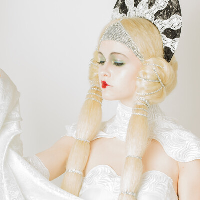 Journey back in time to the Roaring Twenties with Lena D. as she embodies the elegance of Erté-inspired beauty. Hair, makeup, and photography by Anett Alexandra Bulano. 💫✨ #ErtéElegance #1920sGlamour #EditorialBeauty Editorial beauty portrait of model Lena D. adorned in Erté-inspired attire, featuring intricate hair styling and glamorous 1920s makeup.