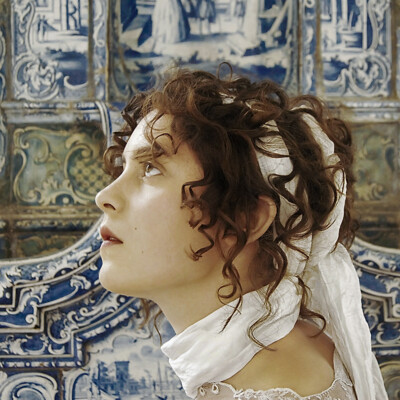Step into the enchanting world of the Regency era with Hannah R. and her exquisite Empire period hairstyle and makeup from 1805-1810. Every curl and ribbon, meticulously crafted by hairstylist, makeup artist, and photographer Anett Alexandra Bulano, transports us to a bygone era of grace and sophistication. #RegencyReverie #EmpireElegance 🌹👑✨ Close-up portrait of model Hannah R. showcasing an Empire period Regency hairstyle and period-specific makeup from 1805-1810. The hairstyle, inspired by ancient Roman influences, features intricate curls and delicate ribbons, perfectly capturing the elegance of the era. Photographed by Anett Alexandra Bulano.