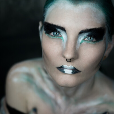 Dive into the world of avant-garde beauty with Lexa Throk, as she embodies the fierce elegance of an abstract falcon lady. Makeup by Anett Alexandra Bulano. 🎨✨ #AbstractBeauty #TurquoiseElegance #FalconLady Portrait of model Lexa Throk showcasing experimental turquoise green and white makeup, evoking the spirit of an abstract falcon lady.