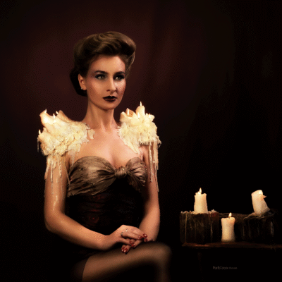 Experience the fusion of past elegance and modern artistry with model Anna Povarova in this captivating image. Hairstyling, makeup, and props by Anett Alexandra Bulano. 🕯️✨ #GibsonGirl #ModernElegance #ArtisticVision Modern reinterpretation of the Gibson Girl hairstyle, featuring model Anna Povarova with burning wax candles arranged as shoulder pads.
