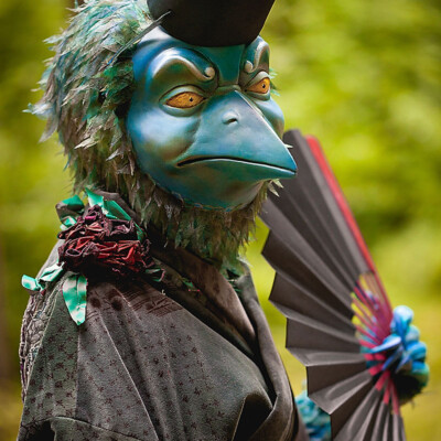 Journey into the realm of legend with this elegant portrait of the Tengu, crafted by Anett Alexandra Bulano. 🦅✨ #JapaneseFolklore #MythicalBeauty #EtherealElegance An elegant portrait of a Tengu holding a Japanese dancing fan against a neutral background.